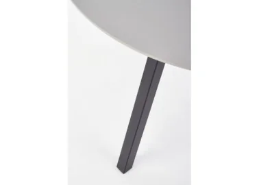 Minimalistinio dizaino šviesiai pilkos spalvos apvalus valgomojo stalas Balrog su juodomis metalinėmis kojelėmis.