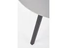 Minimalistinio dizaino šviesiai pilkos spalvos apvalus valgomojo stalas Balrog su juodomis metalinėmis kojelėmis.