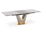 Valentino stalas yra modernus ir prabangus, su V formos metaliniu rėmu, papuoštu auksiniais akcentais. Jis turi šviesų akmens ar marmuro stalviršį, suteikiantį natūralumo ir elegancijos. Apvalus auksinis pagrindas prideda stabilumo ir išskirtinumo, todėl stalas puikiai tinka šiuolaikiškam interjerui.